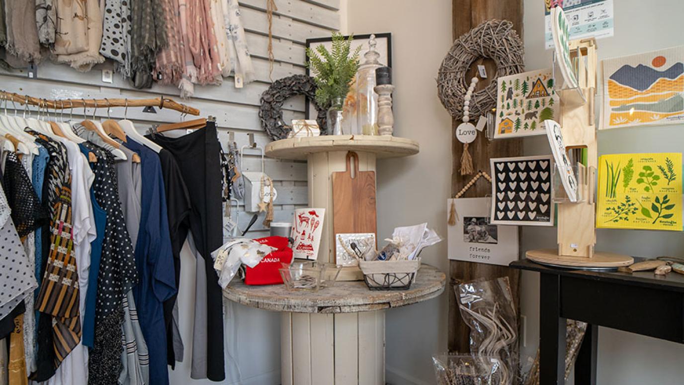 Clothing and gift items displayed on the wall in a small shop