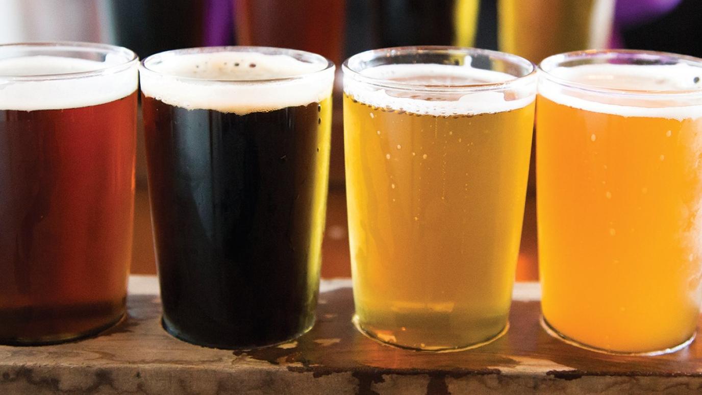 flight of four beers on table