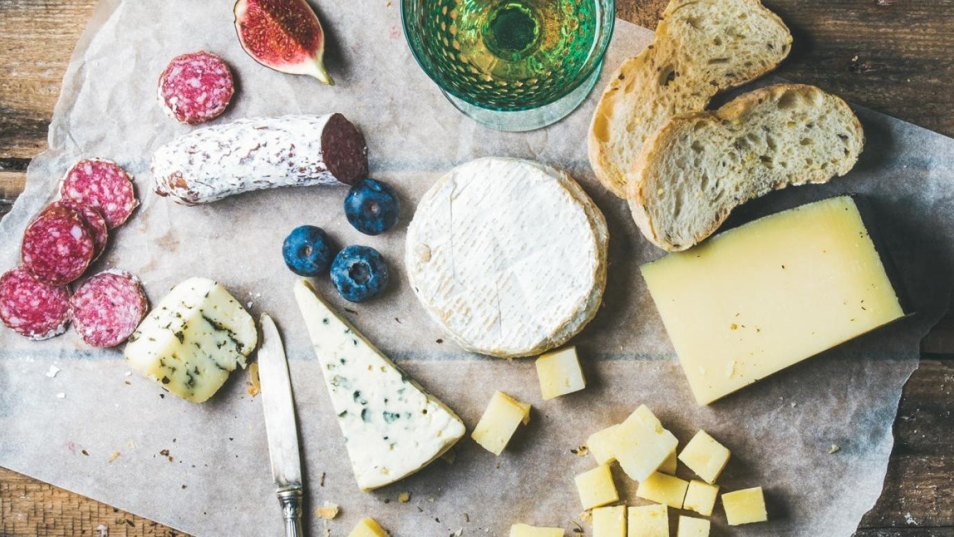 charcuterie board with cheese, meat and bread