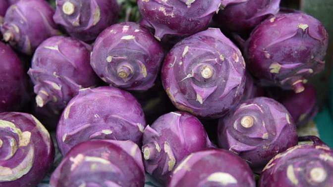 Close up of a stacks of purple kohlrabi
