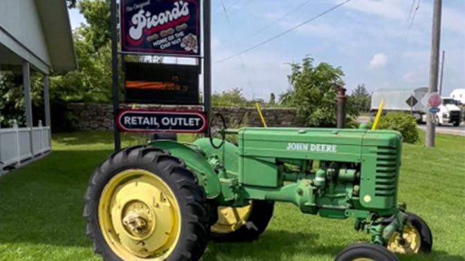 Grean tractor on front lawn of a local confectionery Picards Peanuts
