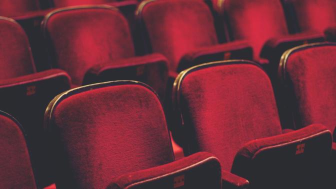 Two rows of red movie theatre seats
