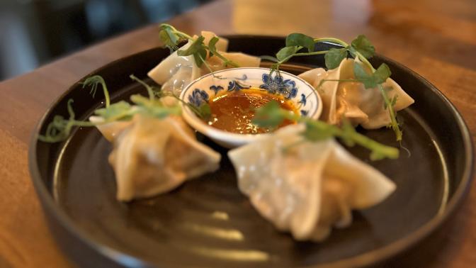 A photo of dumplings with sauce from Tapavino Wine and Tapas Bar.