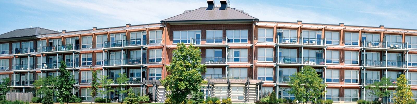 A condo building, several units wide, and about four stories tall.