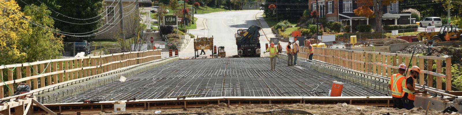 Construction workers repairing a bridge