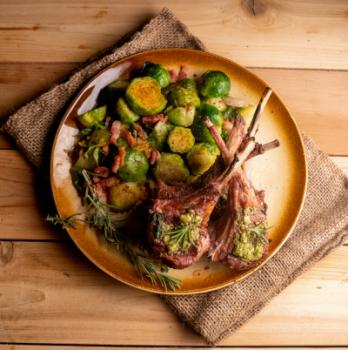 Lamb served with brussel sprouts and garnished using thyme