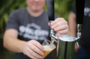 A person is filling a glass with beer
