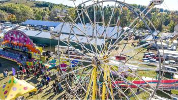 Aerial view of a large Ferris wheel spinning above the Erin Fall Fair grounds