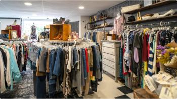 The interior of The Pretty Penny, showcasing racks of vintage clothes and accessories. 
