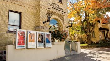 Image of the exterior of a yellow brick building with a sign for Drayton Festival Theatre. 
