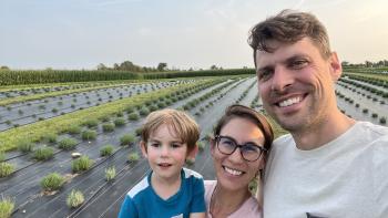 Family standing in from of lavender farm field