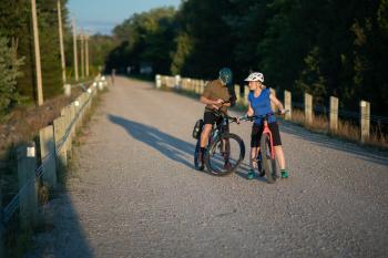 two bikers looking for directions on their phone