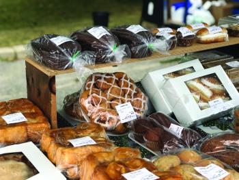 baked goods displayed on a table at a farmers market