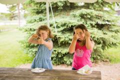 Two girls watching for birds outside