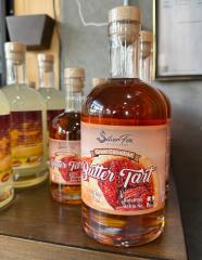 bottle of Butter Tart Liqueur on a shelf with others in the background
