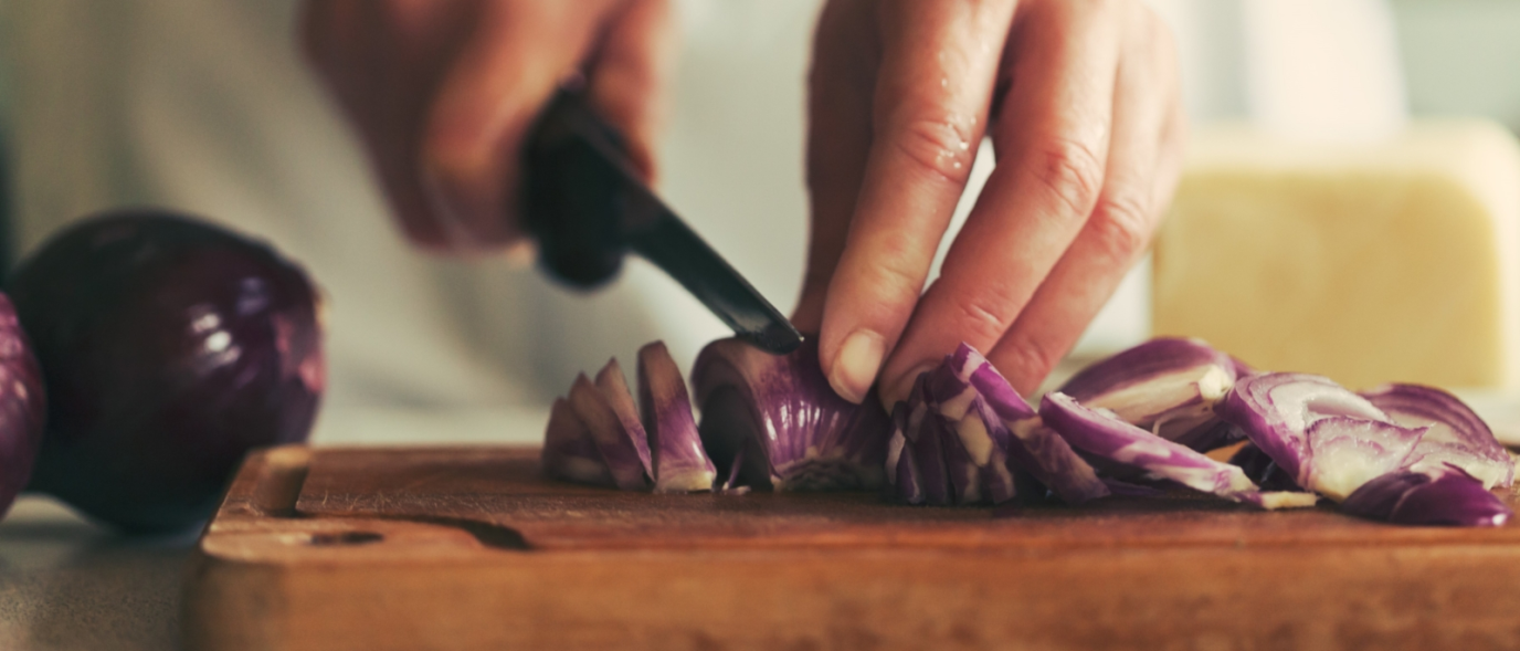 Onions being chopped on a chopping board