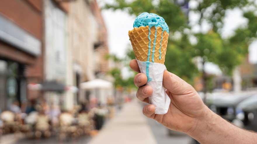 Hand holding out an ice cream cone