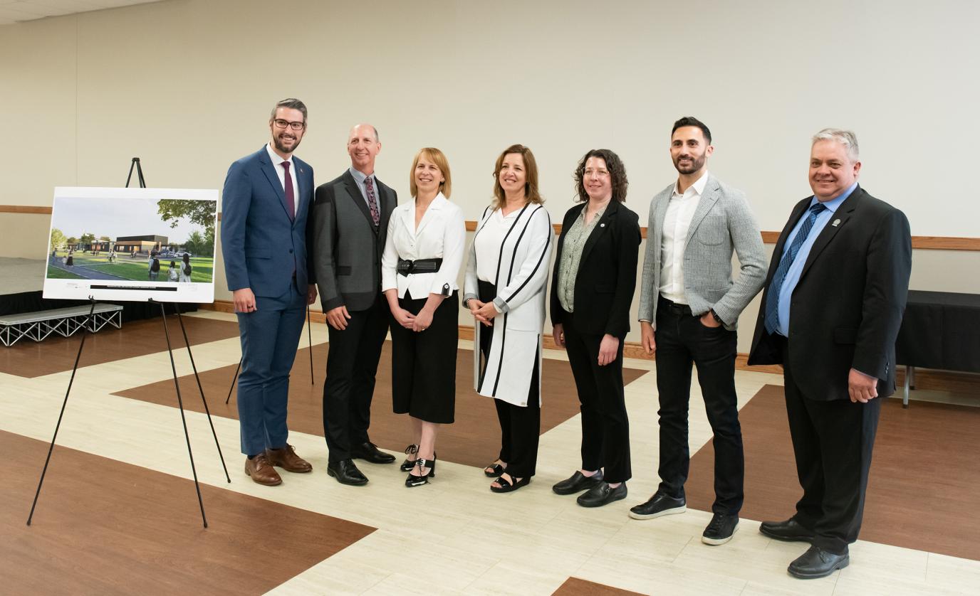 Group of people standing with photo