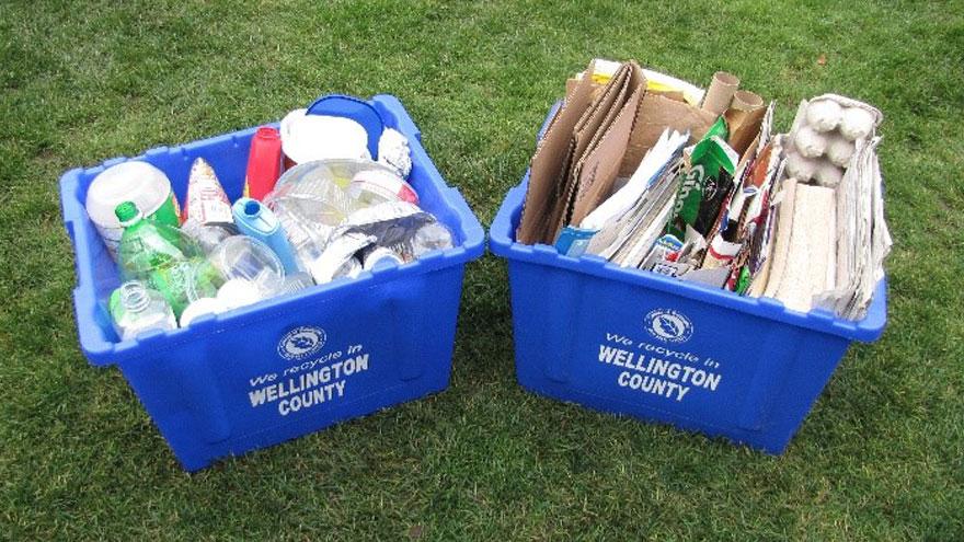 Two blue boxes with containers in one and paper products in the other