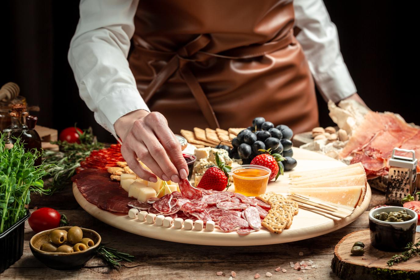caterer plating a charcuterie board